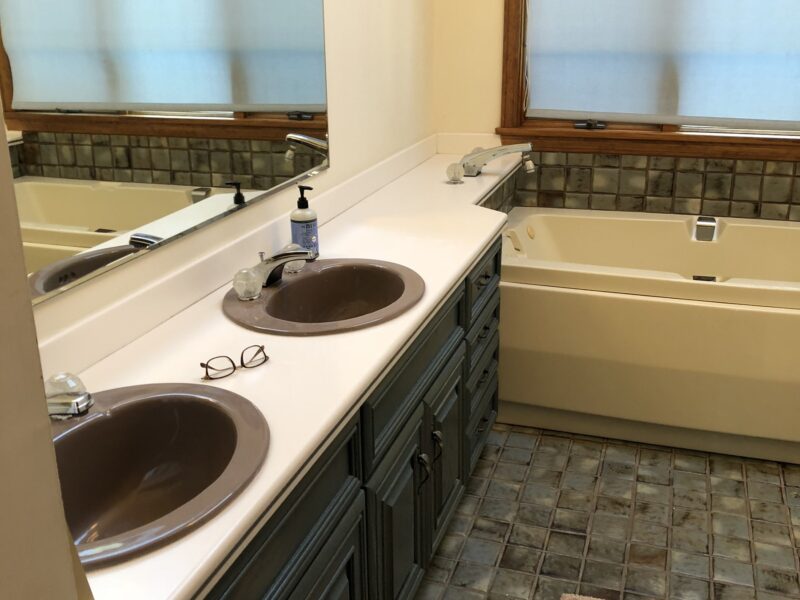 Bathroom shows off its renovation with patterned curtains and soap dispenser – McPhee Associates of Cape Cod.