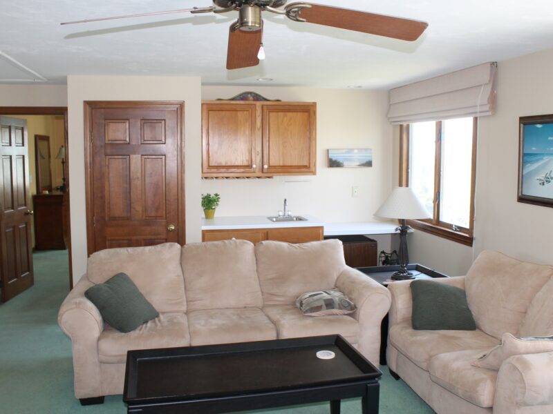 A before photo of the upstairs family room in a 1970s colonial in Dennis, MA, before it was remodeled by McPhee Associates of Cape Cod.