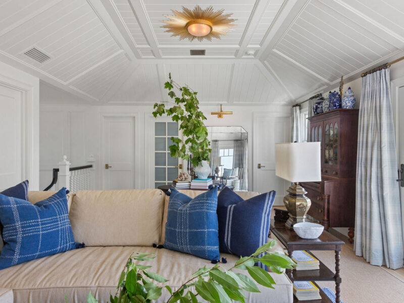 Sunlit space with plants, ceramics, and balcony doors after home renovations – McPhee Associates of Cape Cod.
